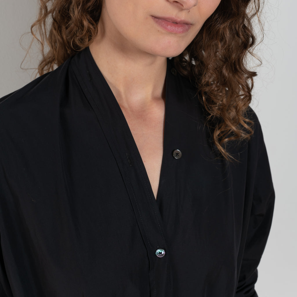 The Collarless Shirtdress by 6397 is a superfine cotton dress with a soft sheerness and full button closure
