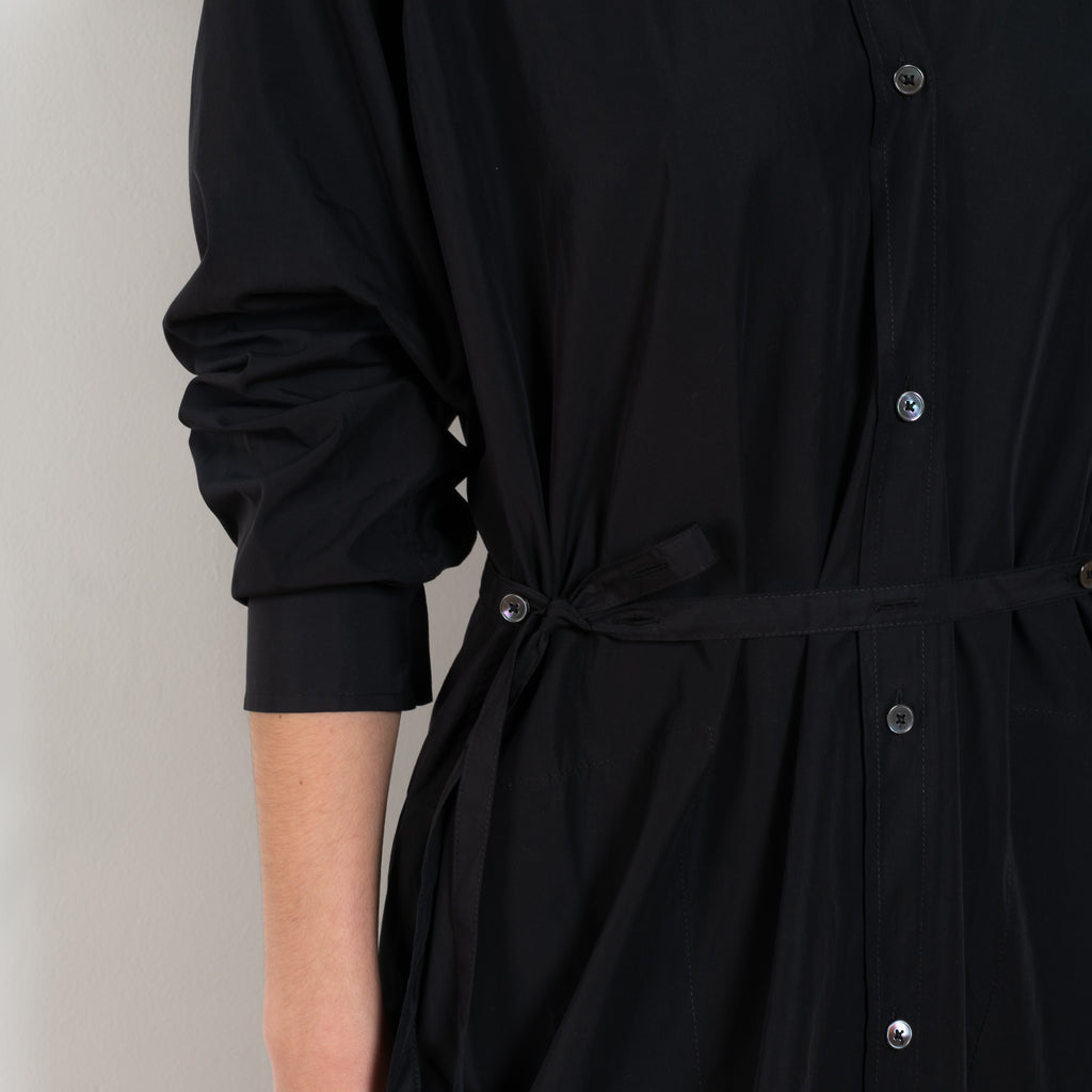 The Collarless Shirtdress by 6397 is a superfine cotton dress with a soft sheerness and full button closure