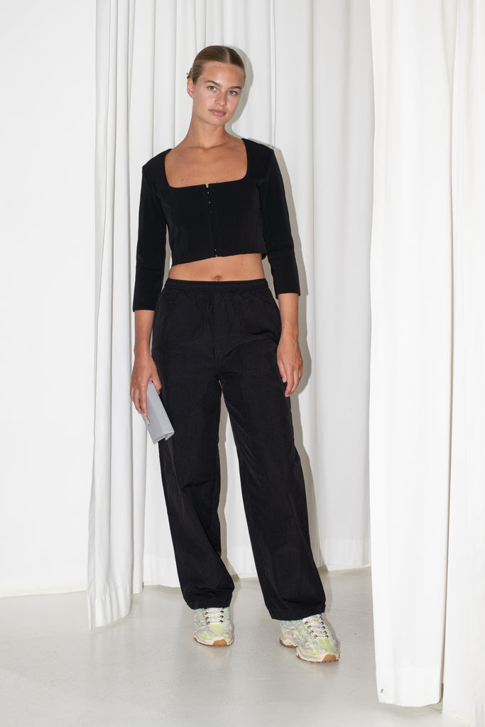 The Hooked Top 852 by Acne Studios is a cropped top with front hook and eye closure, a square-cut neckline and a zipper closure