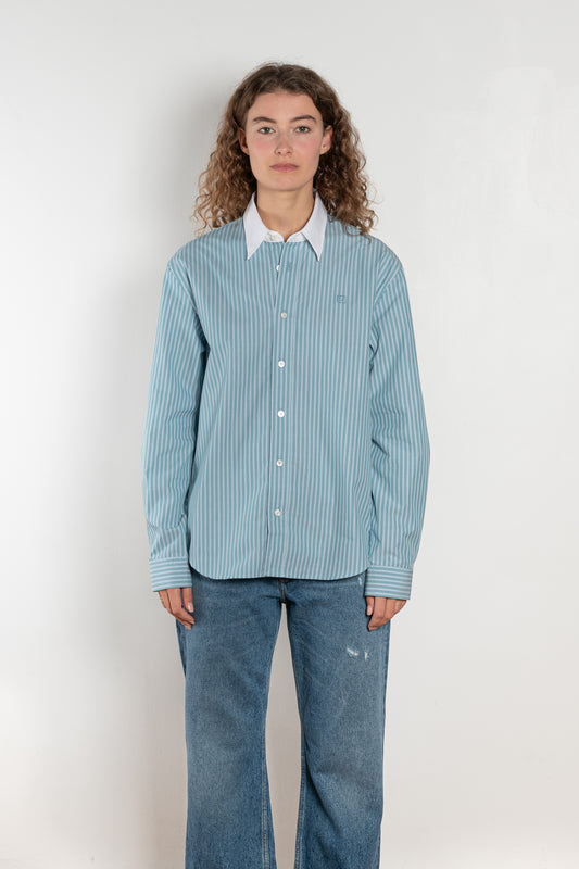 The Button Up Shirt by Acne Studios is a long sleeve button-up shirt with a stripe pattern and contrast collar
