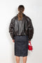 The Coated Bomber by Acne Studios has a coated leather finish