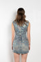 The Coated Denim Dress by Acne Studios is a sleeveless cotton denim twill dress with an iridescent and coated finish