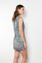 The Coated Denim Dress by Acne Studios is a sleeveless cotton denim twill dress with an iridescent and coated finish