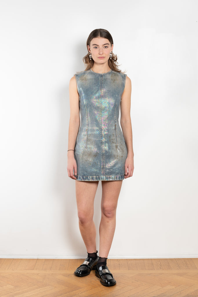 The Coated Denim Dress by Acne Studios is a sleeveless cotton denim twill dress with an iridescent and coated finish