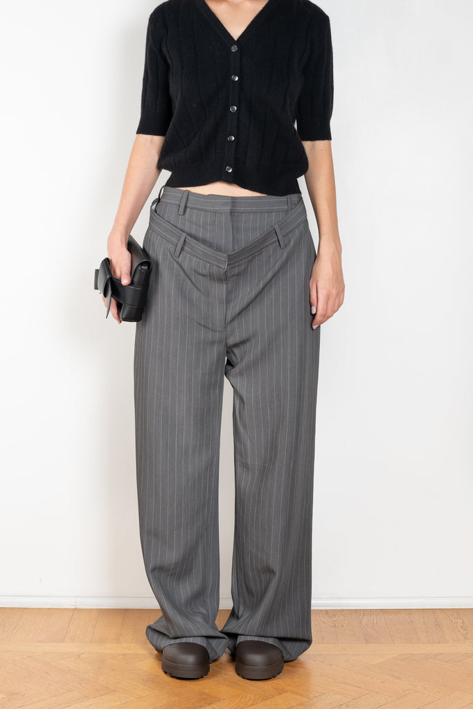 The Deconstructed Pinstripe Trouser  by Acne Studios feature a classic pinstripe pattern, characterised by a deconstructed double-layered belt loop and waist