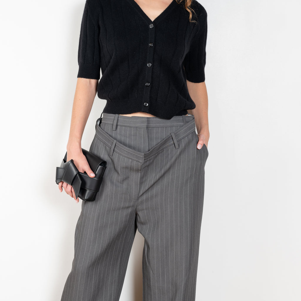 The Deconstructed Pinstripe Trouser by Acne Studios feature a classic pinstripe pattern, characterised by a deconstructed double-layered belt loop and waist