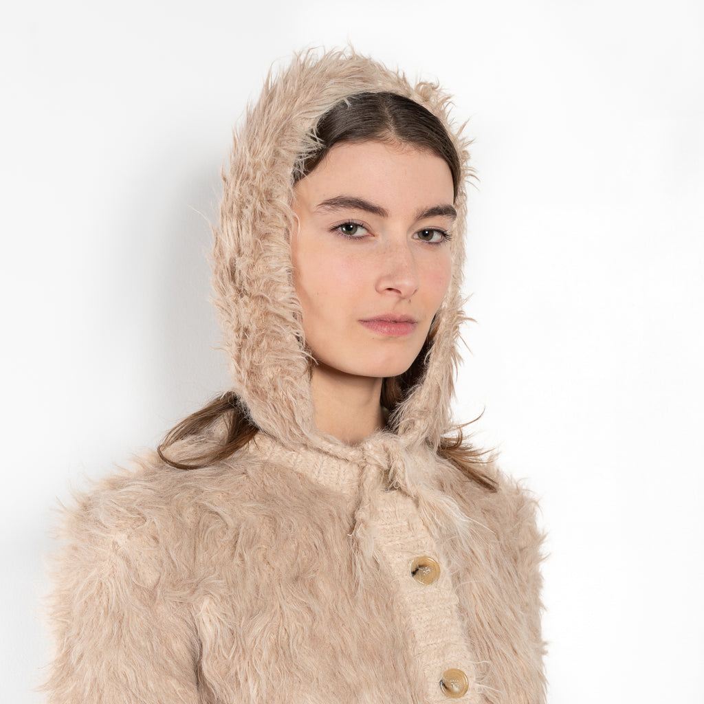 The Fluffy Hat by Acne Studios features a fluffy finish and soft hand-feel with ear straps and tie-up closure.