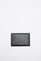 The Folded Leather Wallet by Acne Studios features a folded opening with card slot compartments, crafted from smooth leather and detailed with an Acne Studios logo on the front