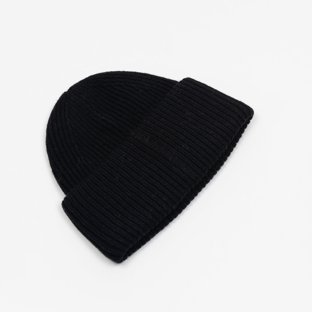 The Small Face Logo Beanie by Acne Studios features a small embroidered face logo patch and ribbed detailing, crafted from chunky wool.