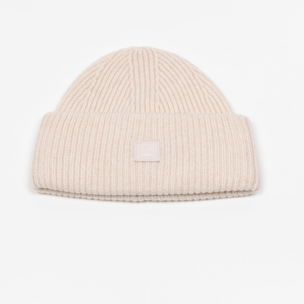 The Small Face Logo Beanie by Acne Studios features a small embroidered face logo patch and ribbed detailing, crafted from chunky wool.