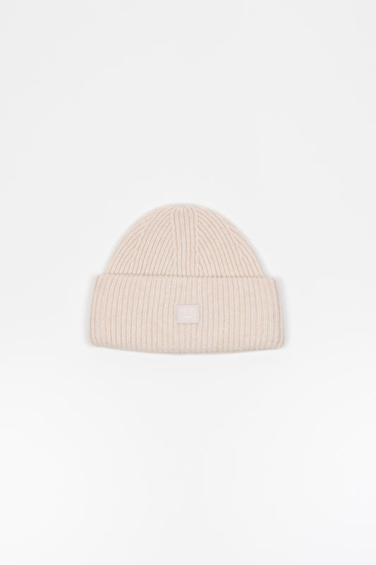 The Small Face Logo Beanie by Acne Studios features a small embroidered face logo patch and ribbed detailing, crafted from chunky wool.