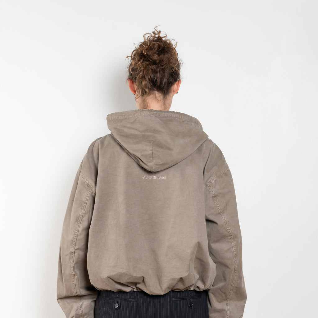 The Hooded Bomber Jacketby Acne Studios is crafted from twill cotton with a garment-dyed finish,&nbsp; centre front zipper closure, side pockets and elasticated waistband