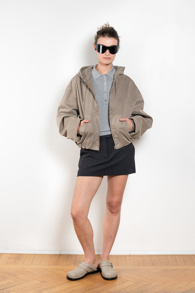 The Hooded Bomber Jacketby Acne Studios is crafted from twill cotton with a garment-dyed finish,&nbsp; centre front zipper closure, side pockets and elasticated waistband