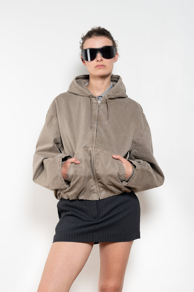 The Hooded Bomber Jacketby Acne Studios is crafted from twill cotton with a garment-dyed finish,&nbsp; centre front zipper closure, side pockets and elasticated waistband