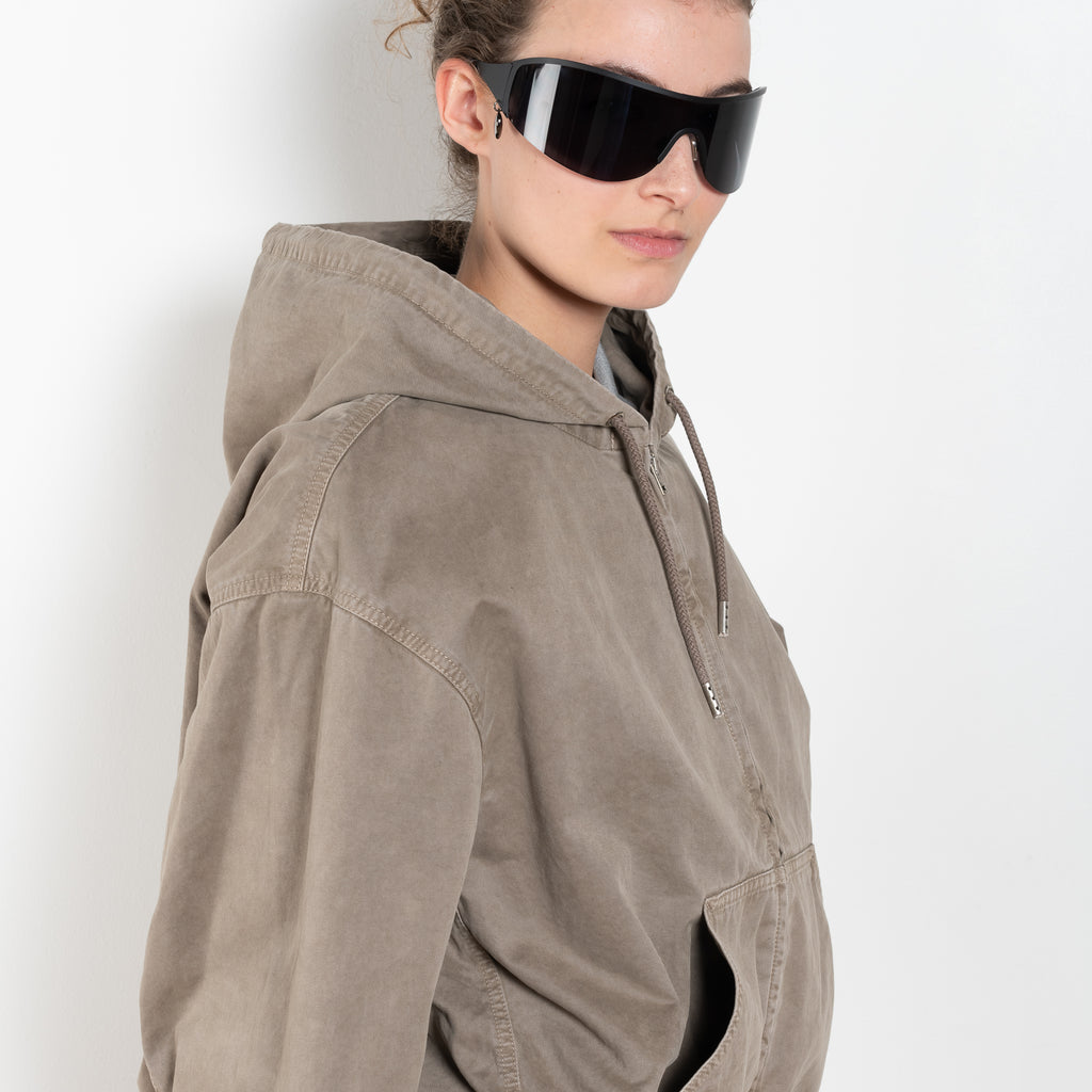 The Hooded Bomber Jacketby Acne Studios is crafted from twill cotton with a garment-dyed finish,&nbsp; centre front zipper closure, side pockets and elasticated waistband