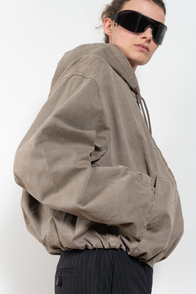 The Hooded Bomber Jacketby Acne Studios is crafted from twill cotton with a garment-dyed finish,&nbsp; centre front zipper closure, side pockets and elasticated waistband