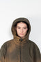 The Hooded Puffed Jacket by Acne Studios has a distinct coated finish crafted from water-repellant nylon