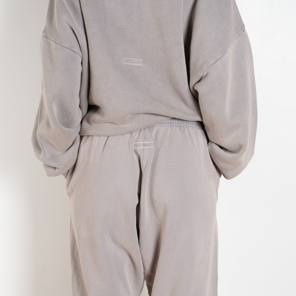 The Jogging 0015 by Acne Studios are mid waist joggers with an elastic waistband and a small rubber logo patch on the back center