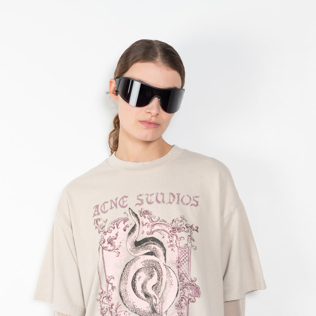 The Layered Tshirt by Acne Studios is a oversized Tee with a seasonal print and layered long sleeves in mesh