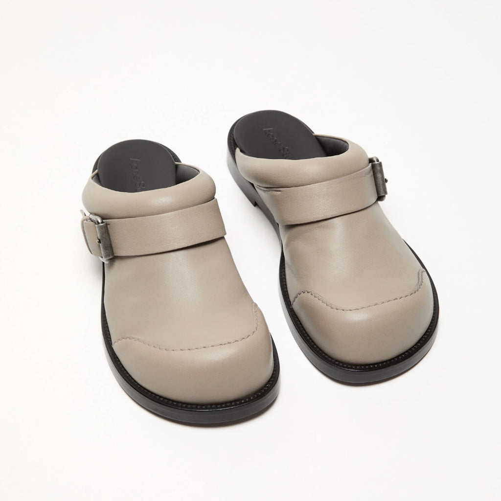 The Leather Buckle Shoes by Acne Studios are mule shoes crafted from soft nappa leather and detailed with branded buckles