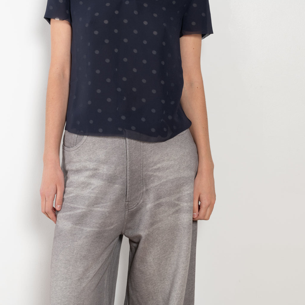 The Loose fit trousers by Acne Studios are fleece melange cotton joggers with a garment dyed finish and leather logo patch at the back