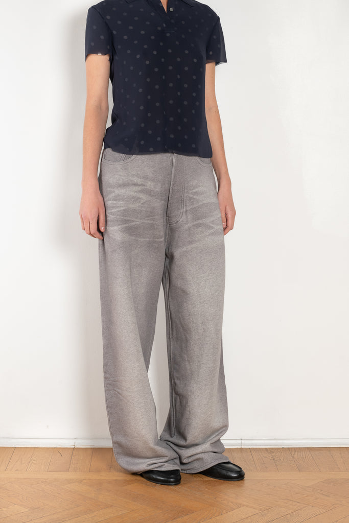 The Loose fit trousers by Acne Studios are fleece melange cotton joggers with a garment dyed finish and leather logo patch at the back