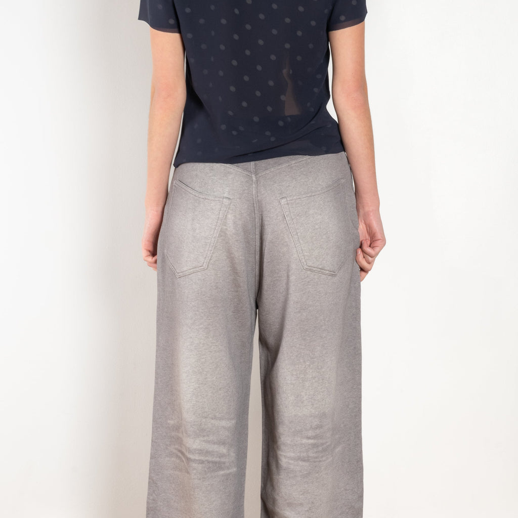 The Loose fit trousers by Acne Studios are fleece melange cotton joggers with a garment dyed finish and leather logo patch at the back