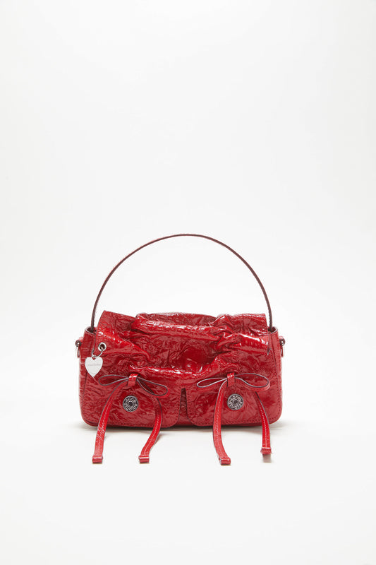 The Multipocket Micro Bag by Acne Studios is crafted from leather with a shiny crinkled finish and laced knot details