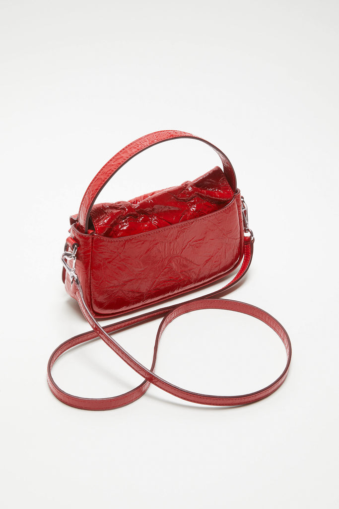 The Multipocket Micro Bag by Acne Studios is crafted from leather with a shiny crinkled finish and laced knot details