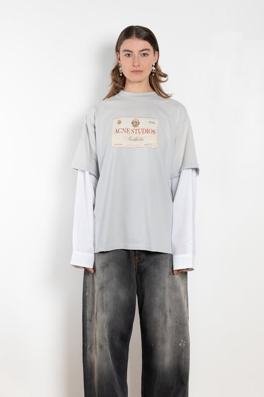 The Layered Print Tee by Acne Studios has a relaxed fit with under-layer mesh long sleeves and distressed neckline