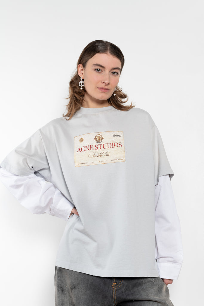 The Layered Print Tee by Acne Studios has a relaxed fit with under-layer mesh long sleeves and distressed neckline