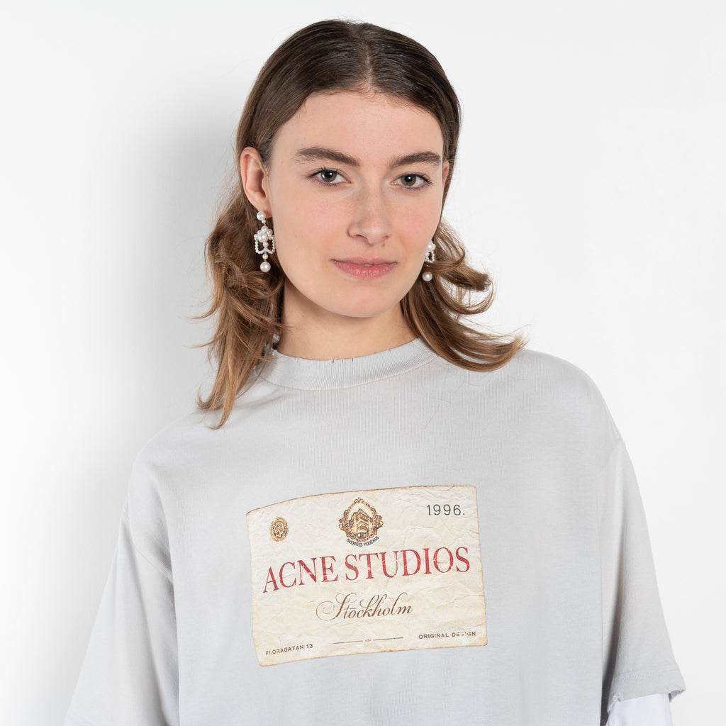 The Layered Print Tee by Acne Studios has a relaxed fit with under-layer mesh long sleeves and distressed neckline