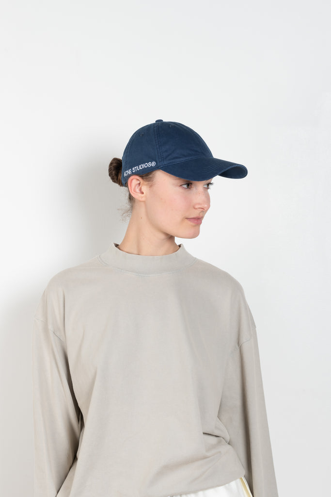 The Cotton Ripstop Cap by Acne Studios is a six-panel baseball cap crafted from ripstop cotton