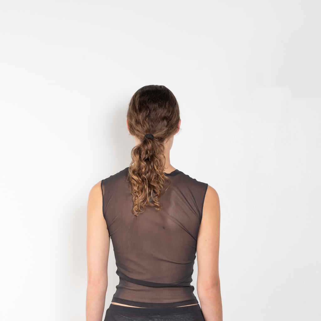 The Cargo Mesh Top by Acne Studios is a semi sheer top with front cargo pocket detailing