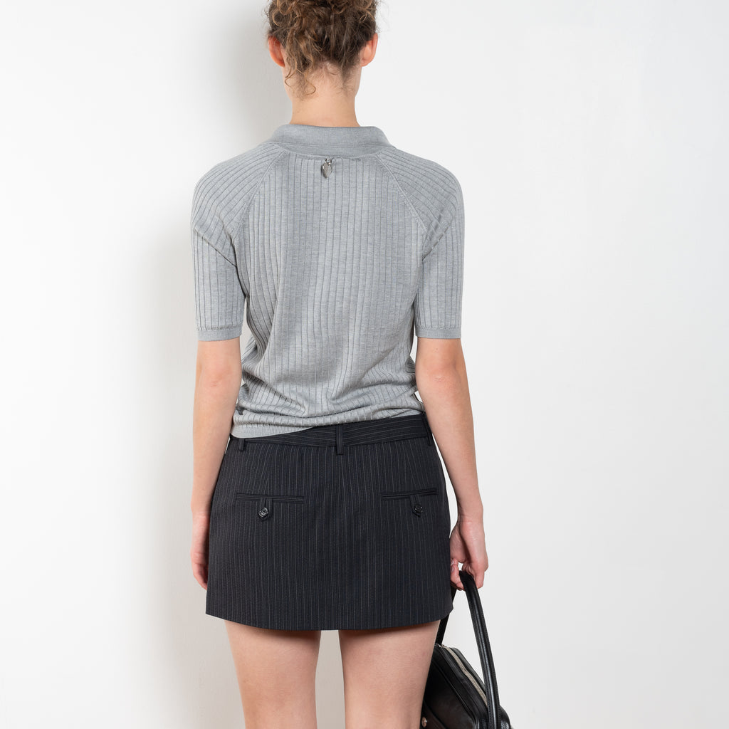 The Short sleeve polo shirt by Acne Studios is a lightweight ribbed silk polo top, detailed with a silver-toned logo engraved heart charm at the back