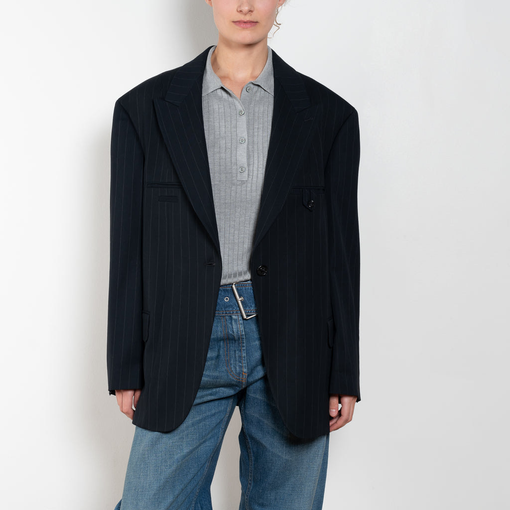 The Single-breasted suit jacket by Acne Studios is crafted in a dense sartorial pinstripe fabric