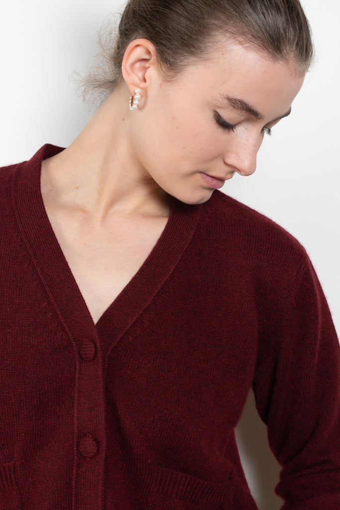 The Granny Cardigan by Alexandra Golovanoff is a signature V-neck cashmere cardigan with cashmere covered buttons