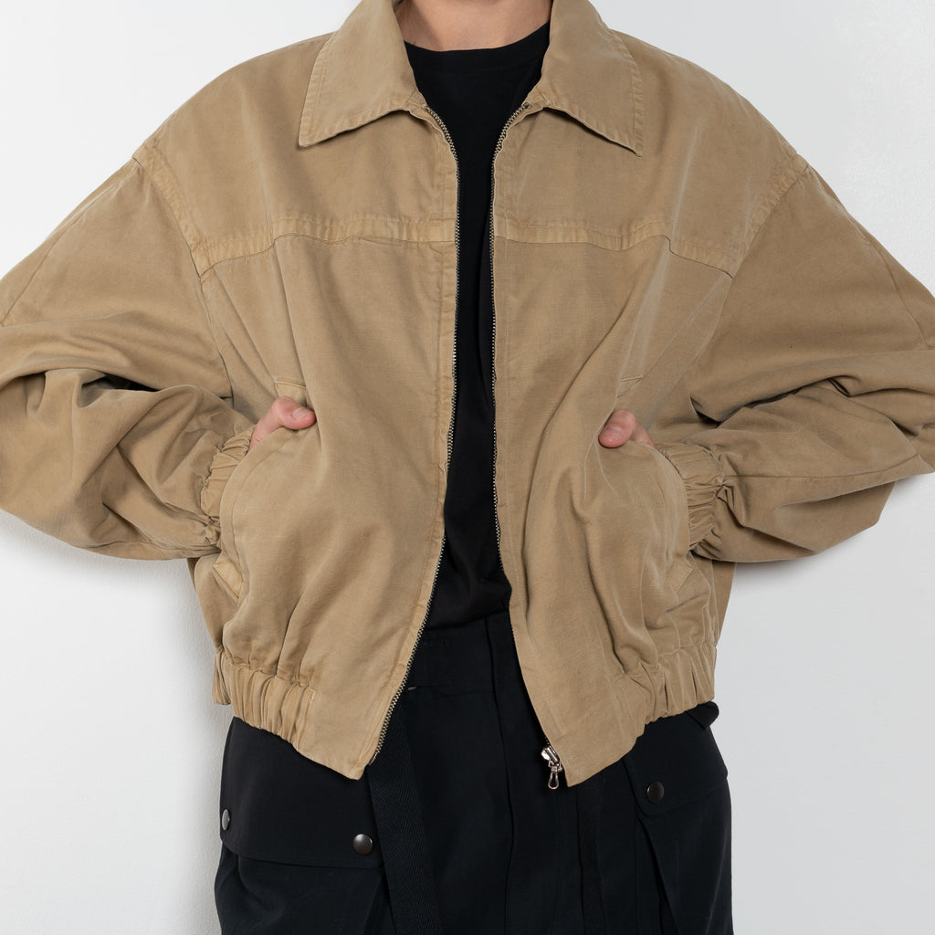 The Gabardine Blouson by Auralee is a short blouson jacket with a natural dye and soft feel