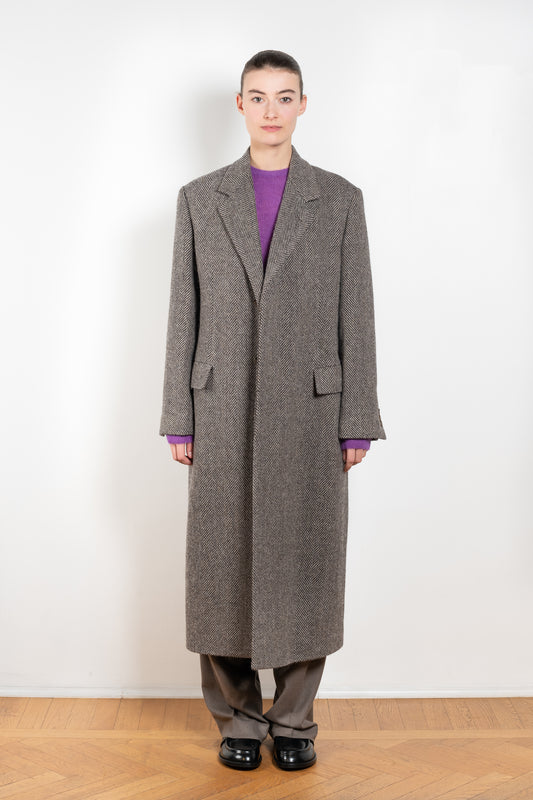 The Chesterfield Coat by Auralee is a lightweight and elegant tweed coat characterized by the crisp texture of British wool and the luxurious, voluminous fibers of alpaca