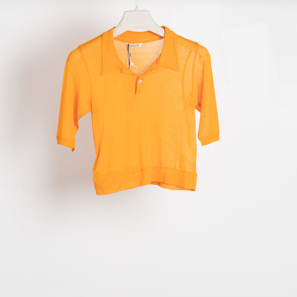 The Gauze Polo by Auralee is a cropped polo top in a vibrant orange sheer cotton jersey