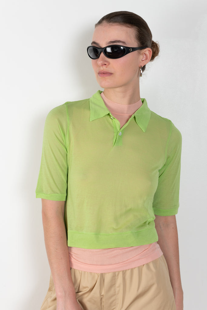 &nbsp;The Gauze Polo by Auralee is a cropped polo top in a vibrant orange sheer cotton jersey