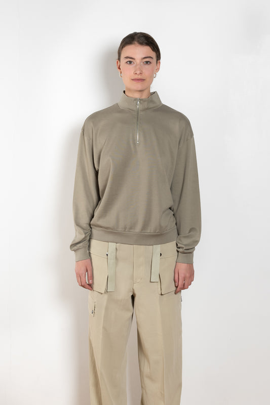The Half Zip Pullover by Auralee is a relaxed sweater with a zipped high collar in a luxurious and lightweight soft cotton