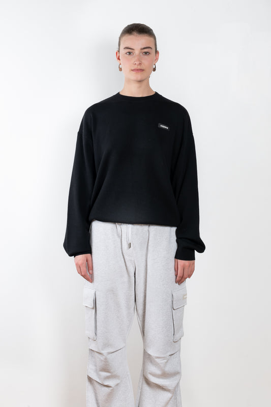 The Branded Crewneck Jumper by Coperni is a signature loose fitted sweater with a small logo on the chest