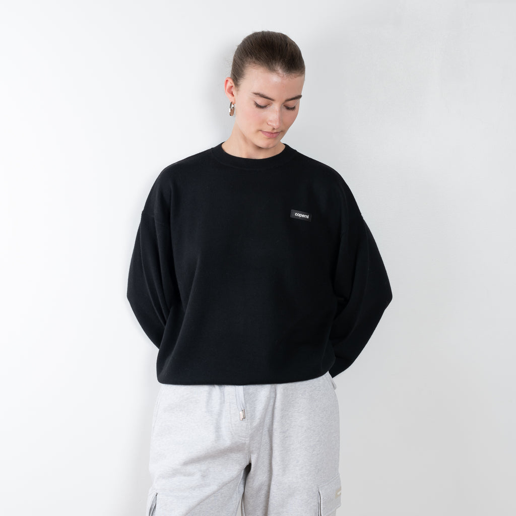 The Branded Crewneck Jumper by Coperni is a signature loose fitted sweater with a small logo on the chest