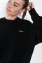 The Branded Crewneck Jumper by Coperni is a signature loose fitted sweater with a small logo on the chest