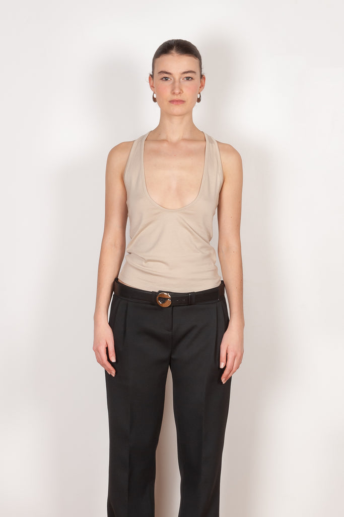 The Deep Cut Tank Top by Coperni is a fitted tank top with a deep cut at the front