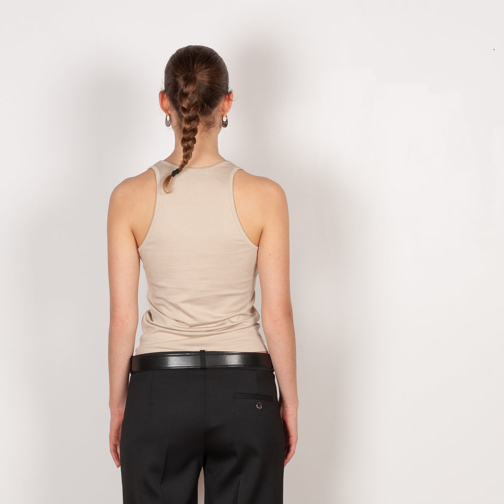 The Deep Cut Tank Top by Coperni is a fitted tank top with a deep cut at the front