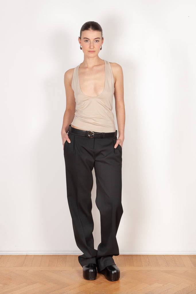 The Deep Cut Tank Top by Coperni is a fitted tank top with a deep cut at the front