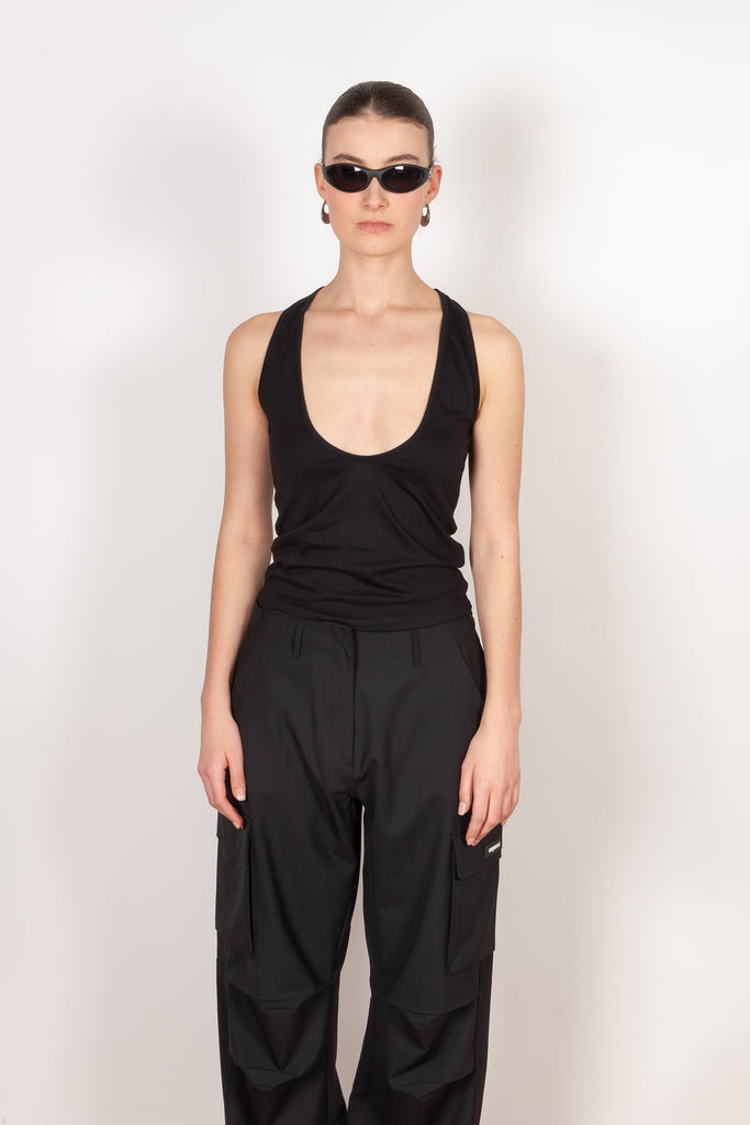 The Deep Cut Tank Top by Coperni is a fitted tank top with a deep cut at the front