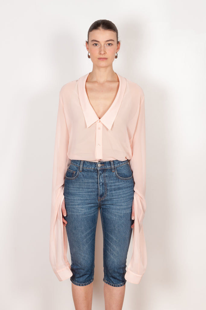 The Open Collar Shirt by Coperni is a crepe shirt with a deep collar and long sleeves meant to be tied up